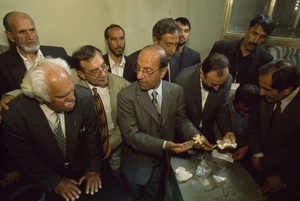 Minister of Information and Culture Sayeed Makhdoom Raheen (center) turns to Viktor Sarianidi (left, front) as the inventory team opens the first safe of Bactrian gold in the presidential bank vault, Kabul 2004 - © Kenneth Garrett, National Geographic Society